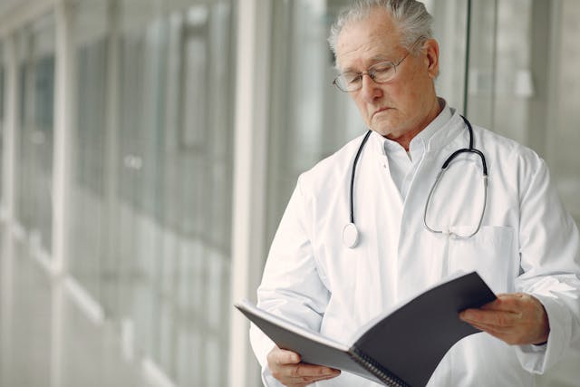 Doctor examining health records.